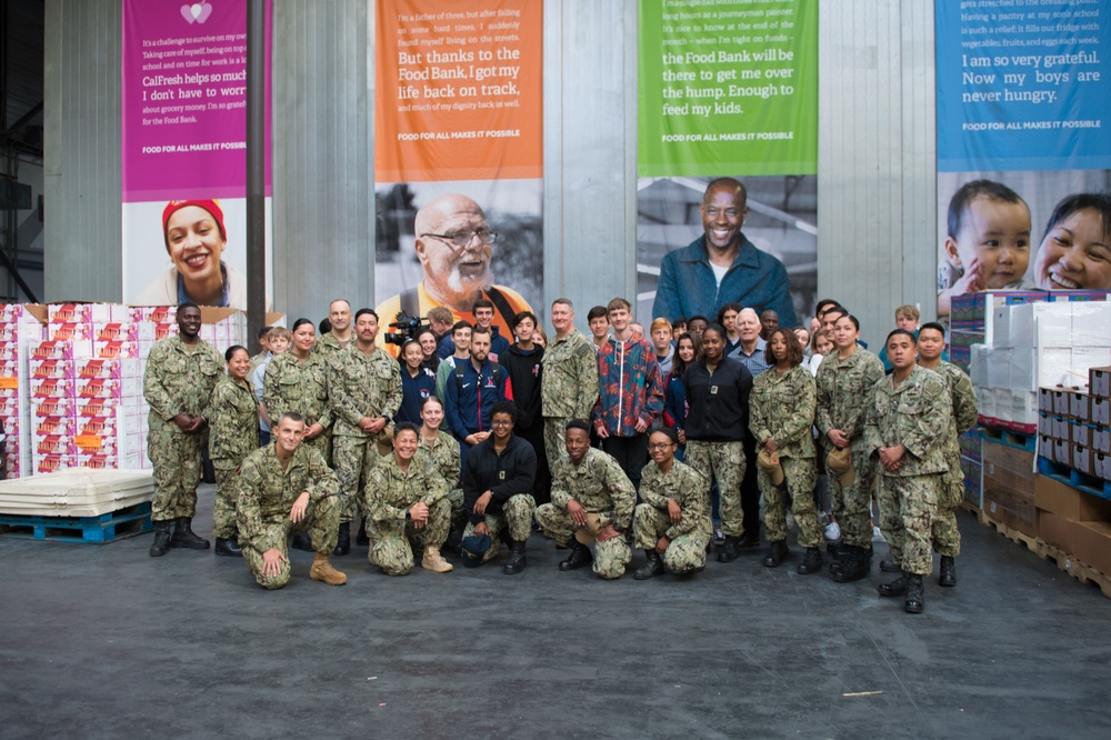 Sailors and Marine Volunteer At Marlin Food Bank