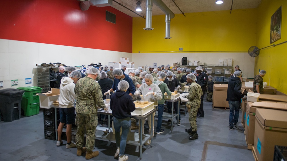 Sailors and Marine Volunteer At Marlin Food Bank