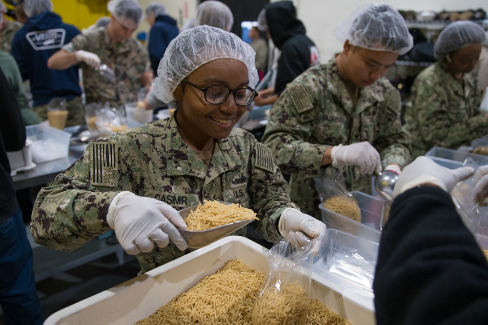 Sailors and Marine Volunteer At Marlin Food Bank