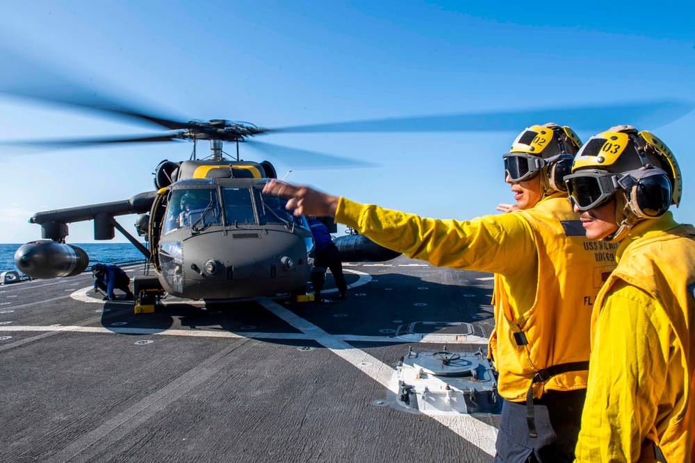 UH-60 Black Hawks from the Army’s 2-2 Assault Helicopter Battalion Conduct Deck Landing Qualifications aboard USS Milius (DDG 69)