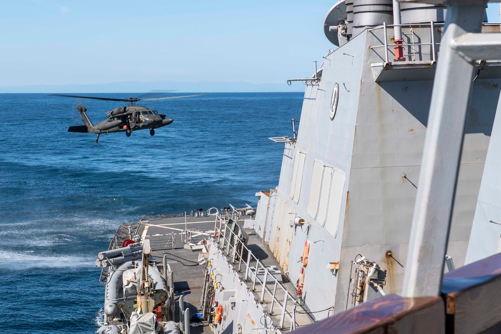 UH-60 Black Hawks from the Army’s 2-2 Assault Helicopter Battalion Conduct Deck Landing Qualifications aboard USS Milius (DDG 69)