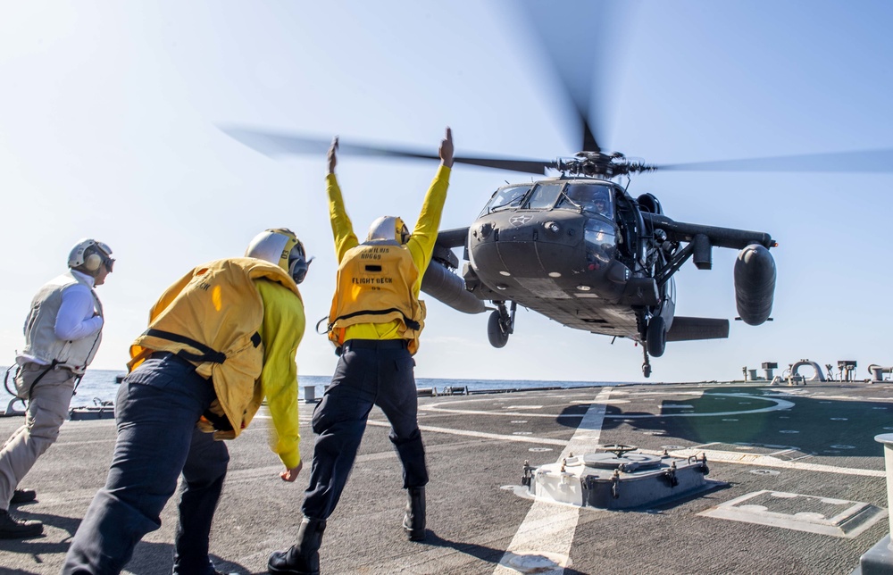 UH-60 Black Hawks from the Army’s 2-2 Assault Helicopter Battalion Conduct Deck Landing Qualifications aboard USS Milius (DDG 69)