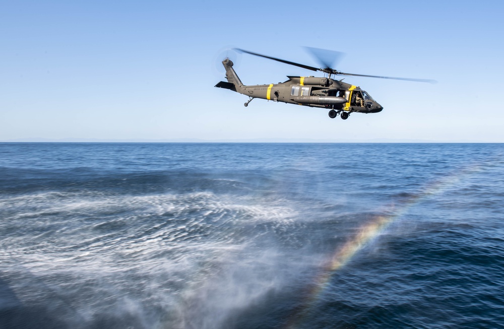 UH-60 Black Hawks from the Army’s 2-2 Assault Helicopter Battalion Conduct Deck Landing Qualifications aboard USS Milius (DDG 69)