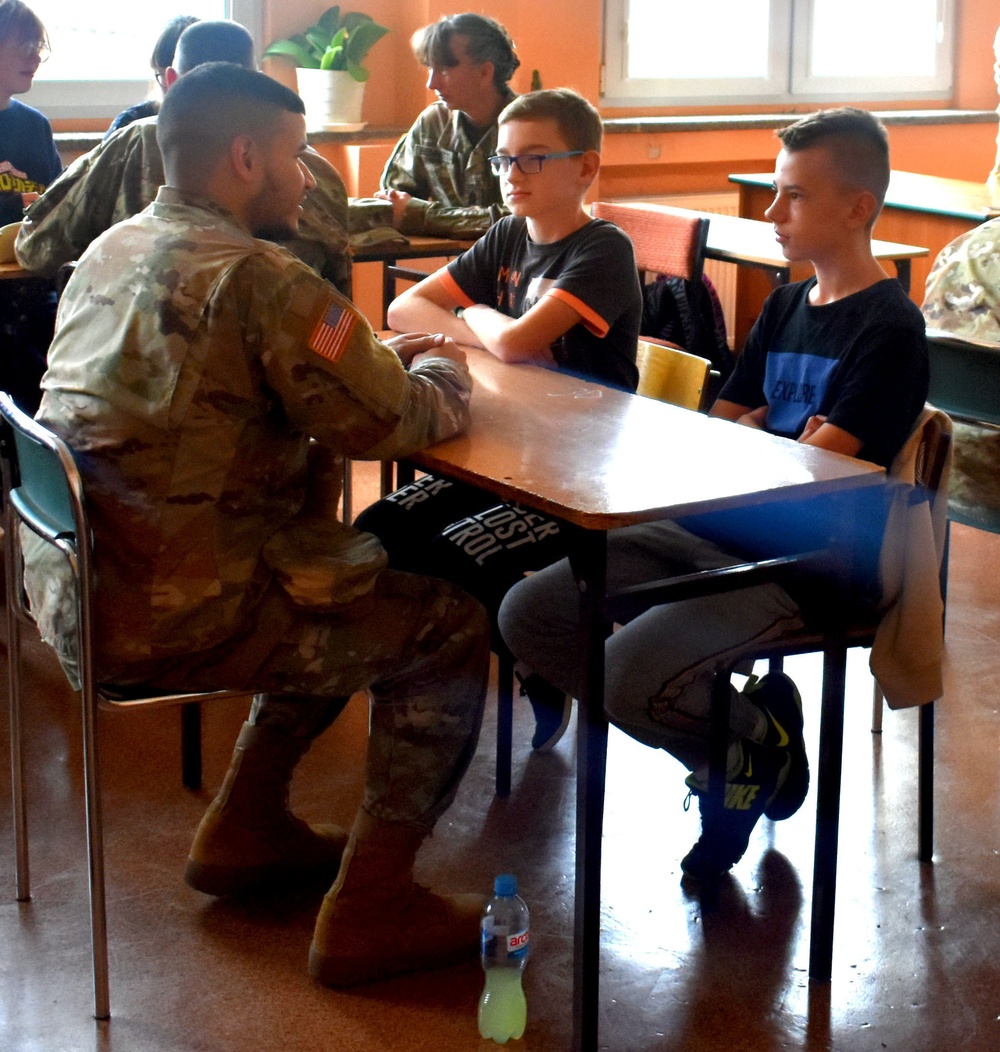 Soldiers and students in a Polish school are sharing their cultures