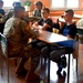 Soldiers and students in a Polish school are sharing their cultures