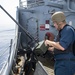 USS Normandy Sailor Loads .50-Caliber Machine Gun During Drill