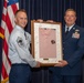 Chief Master Sgt. Jeffrey Linton hands off the pink polo to Chief Master Sgt. Todd Houchens