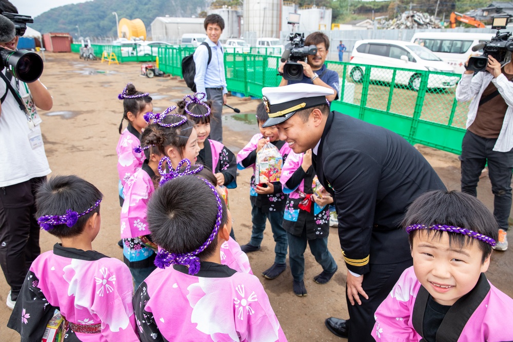 Lt. Saungwon Ko, communications officer of USS Pioneer (MCM 9), speaks with local kindergarteners from Uki city