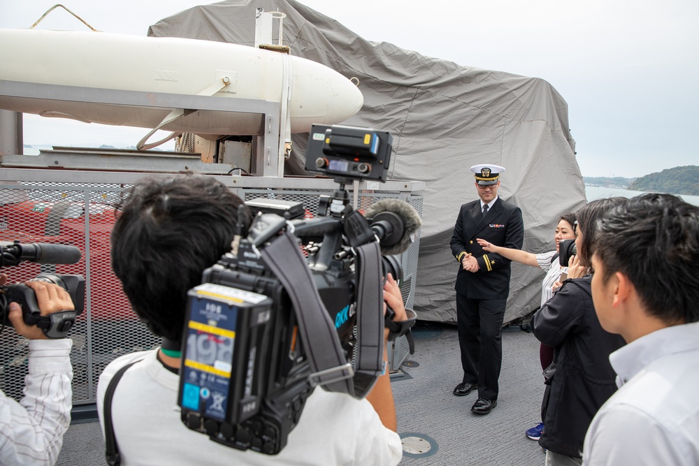 Lt. j.g. Scott Sansing, main propulstion officer of Avenger-class mine countermeasures ship USS Pioneer (MCM 9) gives a ship tour to Uki city media.