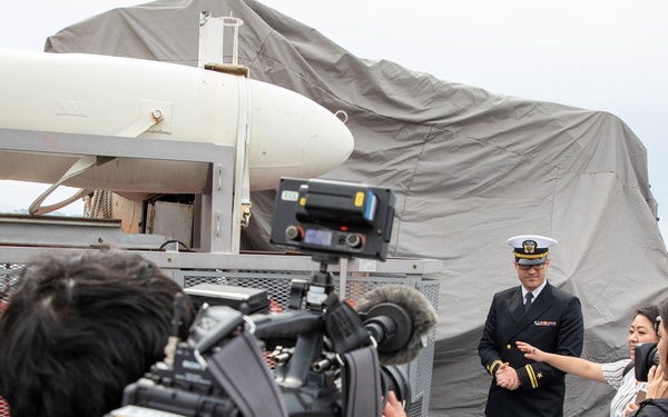 Lt. j.g. Scott Sansing, main propulstion officer of Avenger-class mine countermeasures ship USS Pioneer (MCM 9) gives a ship tour to Uki city media.