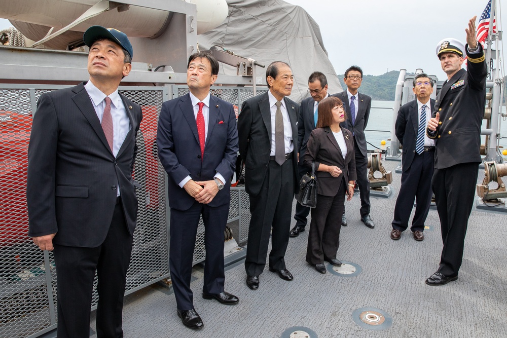 Commanding officer of USS Pioneer (MCM 9), Lt. Cmdr. Bobby Wayland, gives a ship tour to the mayor of Uki city, Kenshi Morita and his staff.