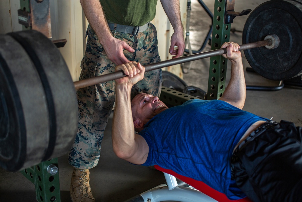 U.S. Marines, Sailors participate in a bench press competition during exercise KAMANDAG 3