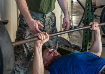 U.S. Marines, Sailors participate in a bench press competition during exercise KAMANDAG 3