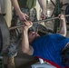 U.S. Marines, Sailors participate in a bench press competition during exercise KAMANDAG 3