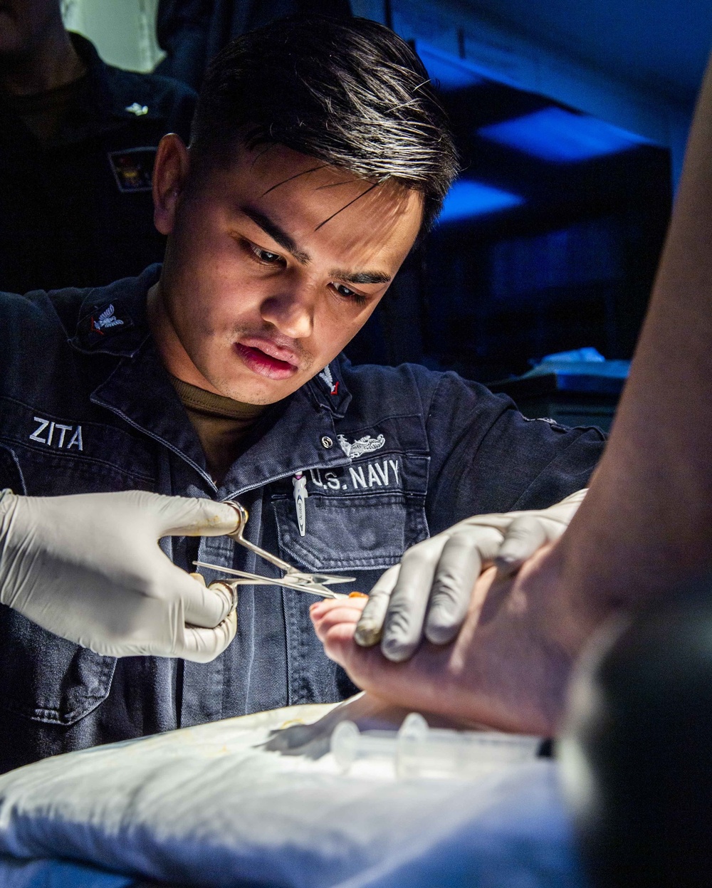 A Sailor Aboard USS Milius (DDG 69) Performs Medical Care