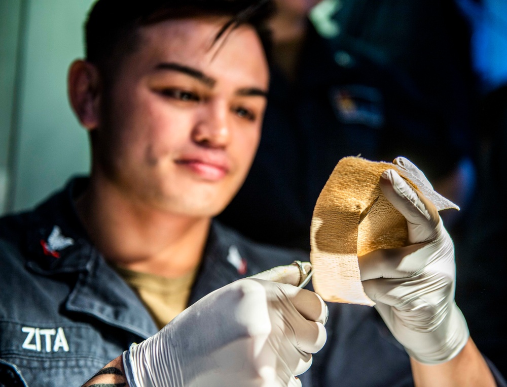 A Sailor Aboard USS Milius (DDG 69) Performs Medical Care