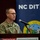 A U.S. Army soldier named Spivey is speaking at a podium during an event hosted by the North Carolina Department of Information Technology (NC DIT). The event appears to be taking place at the McKimmon Conference Center. He is in military camouflage uniform and is addressing an audience using a microphone.