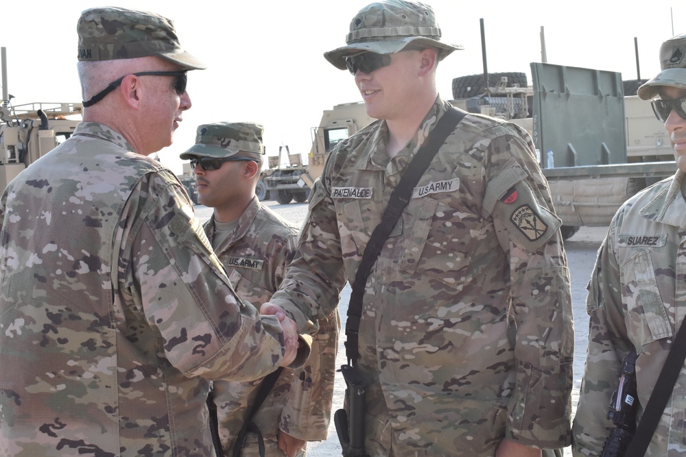 Maj. Gen. John P. Sulivan presents coins to 129th CSSB soldiers