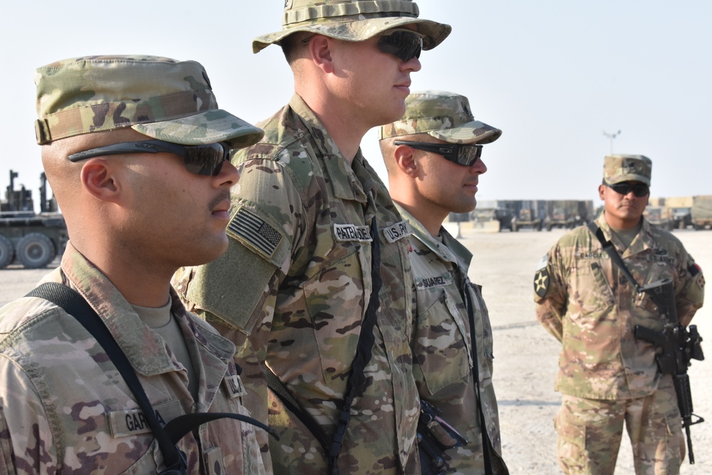 Maj. Gen. John P. Sulivan presents coins to 129th CSSB soldiers