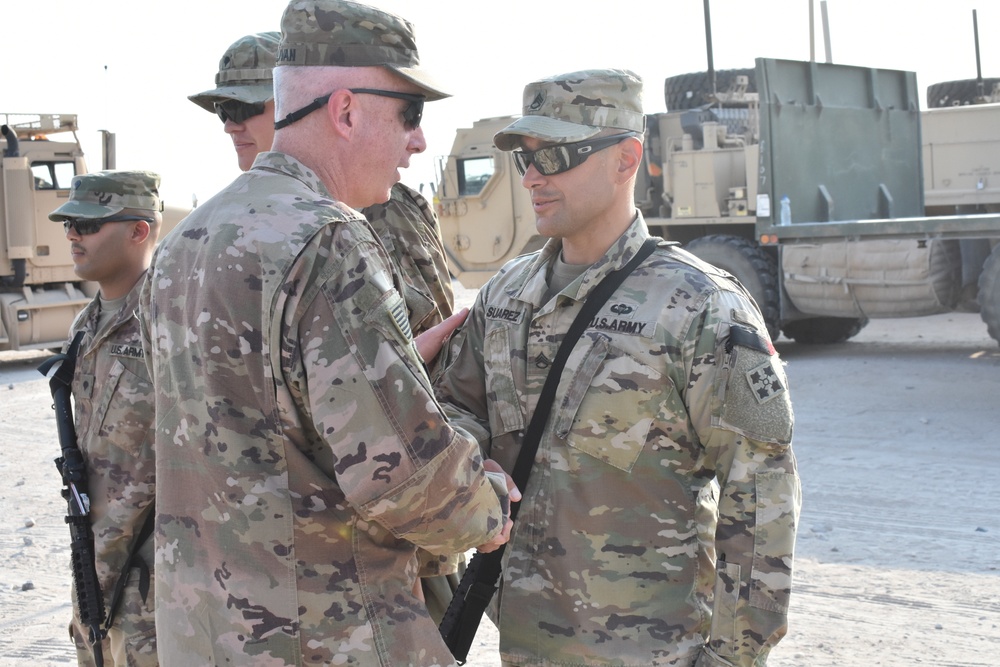 Maj. Gen. John P. Sulivan presents coins to 129th CSSB soldiers