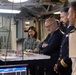 His Excellency Philippe Etienne, center, Ambassador of France to the U.S., observes the flight deck status board in flight deck control