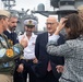 U.S. Navy Vice Adm. Andrew Lewis, left, commander of U.S. 2nd Fleet, speaks with His Excellency Philippe Etienne, center right, Ambassador of France to the U.S., on the flight deck of the aircraft carrier USS John C. Stennis (CVN 74)