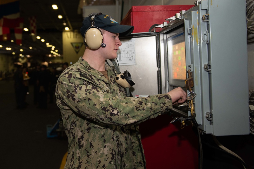 U.S. Sailor operates an elevator on the hangar bay