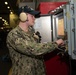 U.S. Sailor operates an elevator on the hangar bay