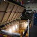 U.S. Sailors lower an industrial elevator on the hangar bay