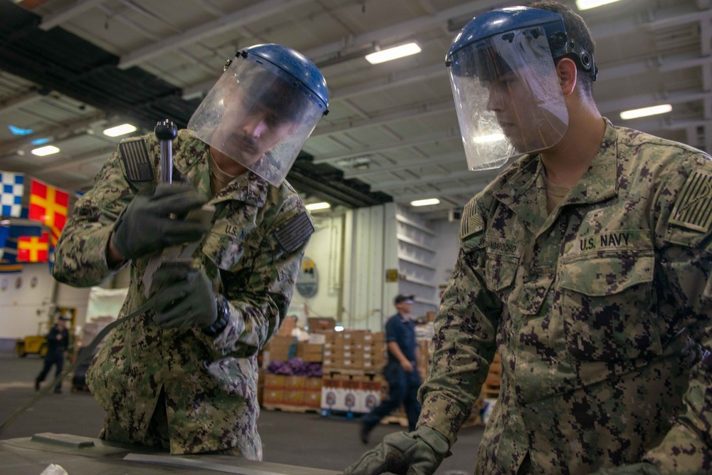 U.S. Sailors band a box