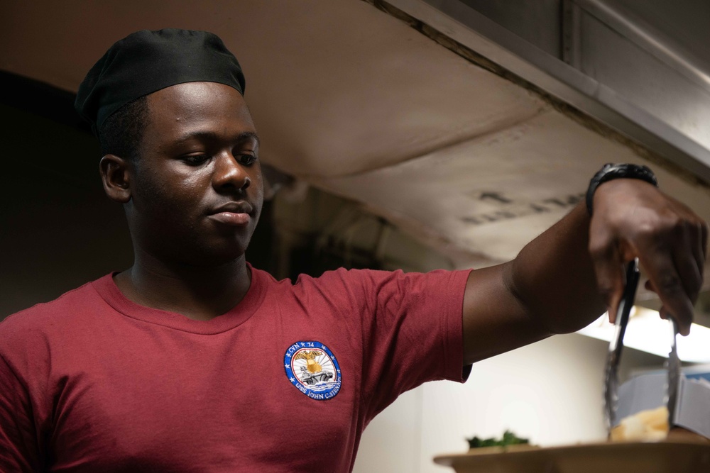 U.S. Sailor serves food