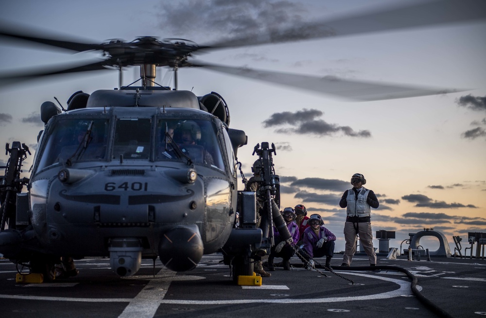 An HH-60 Pave Hawk from the U.S. Air Force’s 33rd Rescue Squadron Conducts Deck Landing Qualifications aboard USS Milius (DDG 69)