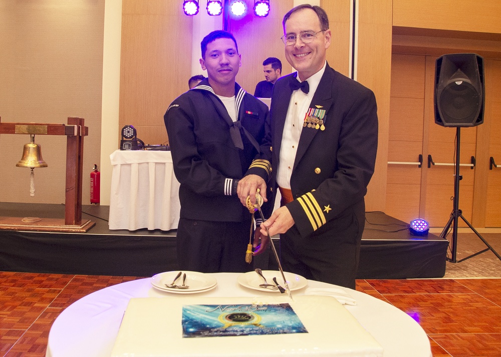 Machinist’s Mate Fireman Brian Lovo and Cdr. Werner J. Rauchenstein, NSA Souda Bay executive officer, cut the cake during the Navy Ball.