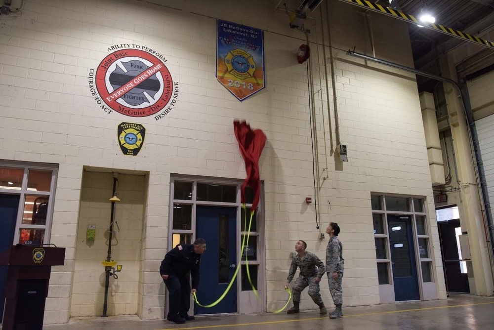 The 87th CES fire department unveils achievement banner