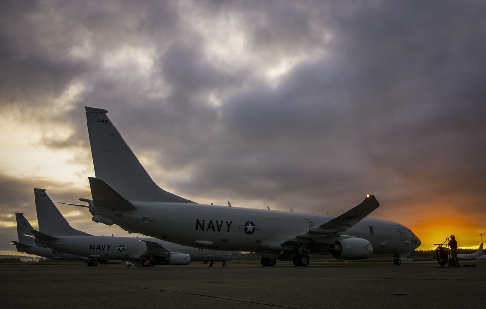 Three P-8A Poseidons recently assigned to the Grey Knights of Patrol Squadron (VP) 46 sit on the flight line.
