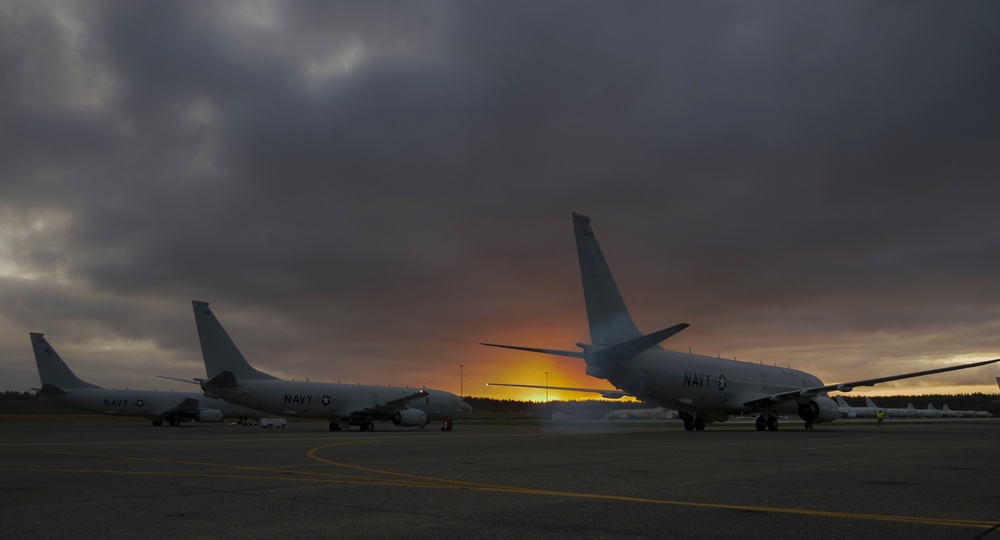 Three P-8A Poseidons recently assigned to the Grey Knights of Patrol Squadron (VP) 46 sit on the flight line.
