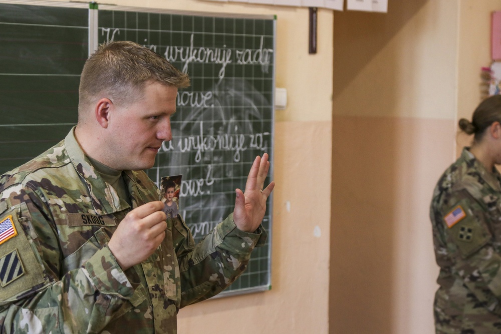 Skoog shows picture of his son to class