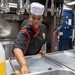 USS McCampbell Sailors prepare meals