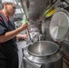 USS McCampbell Sailors prepare meals