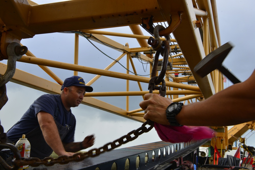 Coast Guard crews maintain equipment aboard the Smilax