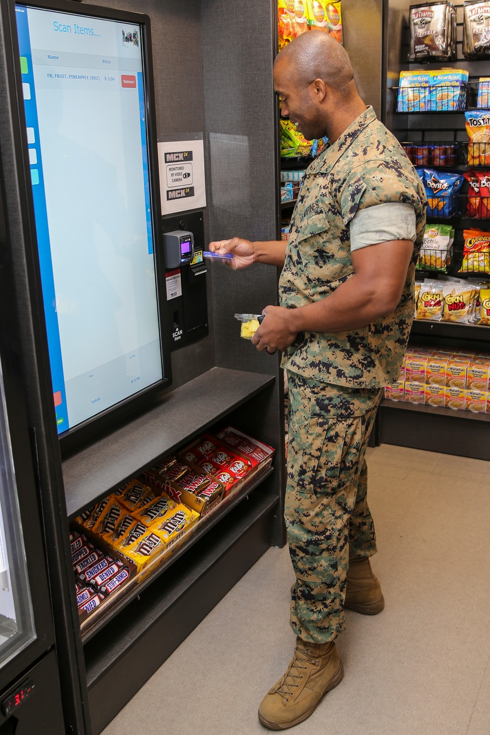 Marines, civilians celebrate mini mart opening at comm facility