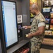 Marines, civilians celebrate mini mart opening at comm facility