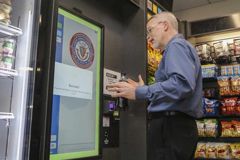 Marines, civilians celebrate mini mart opening at comm facility