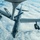 An aerial photograph captures a U.S. Air Force B-52 Stratofortress strategic bomber conducting an aerial refueling operation with a tanker aircraft. The refueling boom from the tanker is extended and connected to the bomber's receptacle on the fuselage. The image is taken from the tanker's boom operator position, looking down at the bomber flying above a cloud layer.