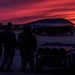 Maintainers assigned from Whiteman watch a sunset near a B-2 Spirit Stealth Bomber