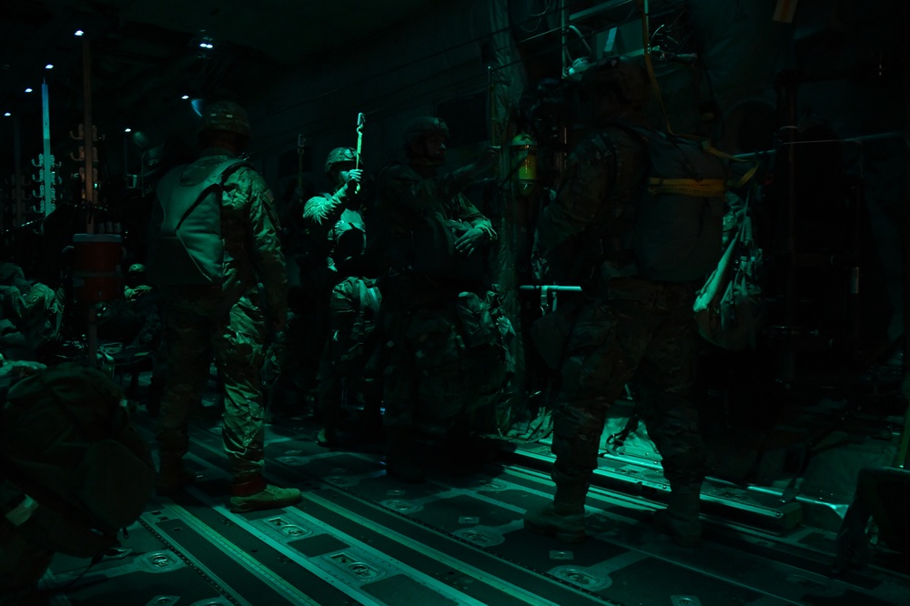 The 143d Airlift Wing, 1/143d Charlie Co. Infantry Airborne, Team Up for High Performance Tactical Night Jump Training