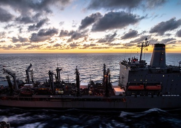 The fleet replenishment oiler USNS Kanawha (T-AO 196) pulls alongside the aircraft carrier USS John C. Stennis (CVN 74) in preparation for a refueling-at-sea