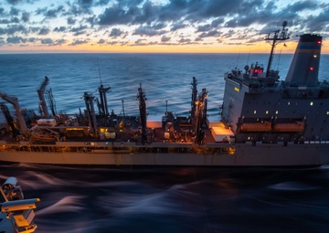 The fleet replenishment oiler USNS Kanawha (T-AO 196) pulls alongside the aircraft carrier USS John C. Stennis (CVN 74) in preparation for a refueling-at-sea