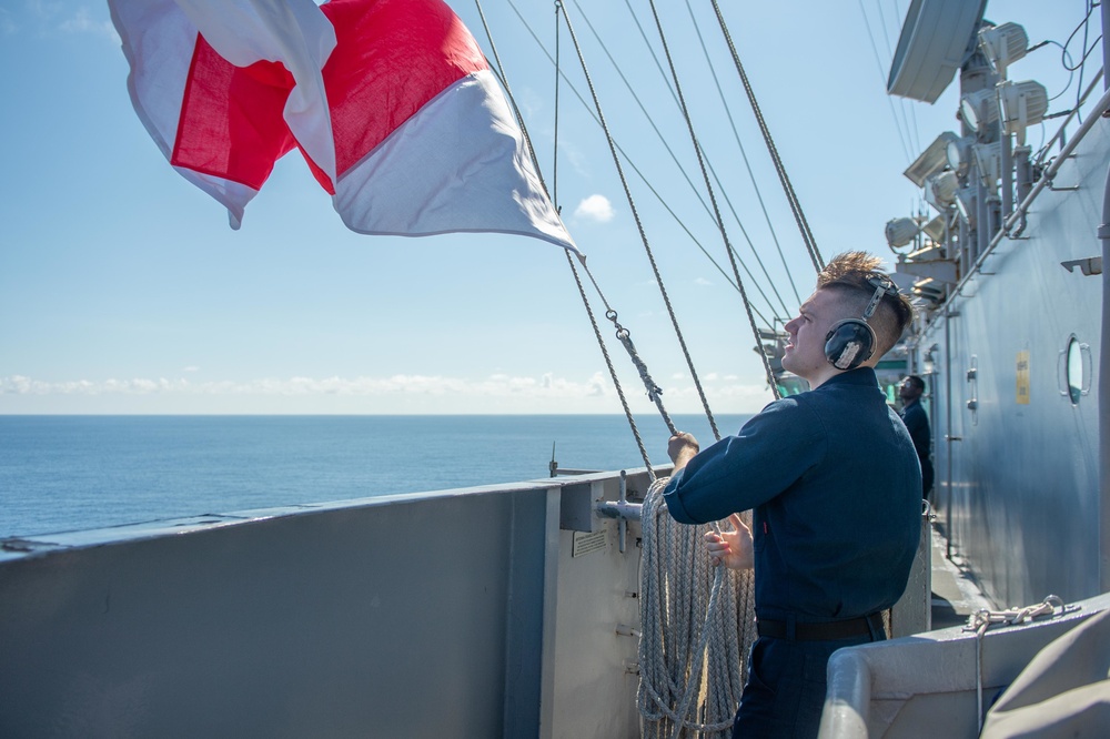 U.S. Navy Sailor raises flag