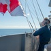 U.S. Navy Sailor raises flag